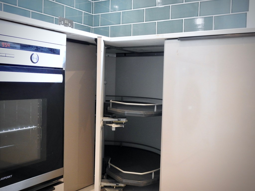 A view of the cupboard with neat storage which folds away. 